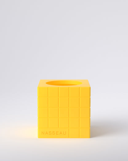 Yellow 3d printed square vase with 'Nasseau' branding on a light gray background